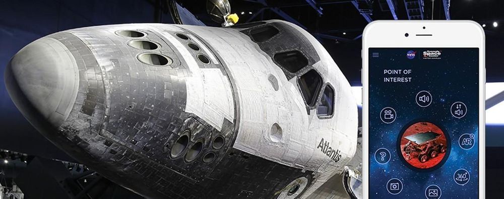 Nose of the Atlantis space shuttle as displayed in the Kennedy Space Center in Florida. Next to it, a phone showing an app to discover points of interest.